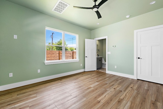 unfurnished bedroom with connected bathroom, ceiling fan, and light hardwood / wood-style floors