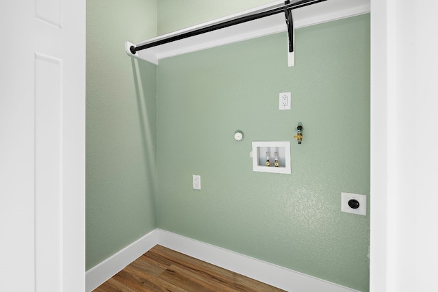 washroom with washer hookup, dark hardwood / wood-style floors, hookup for a gas dryer, and electric dryer hookup