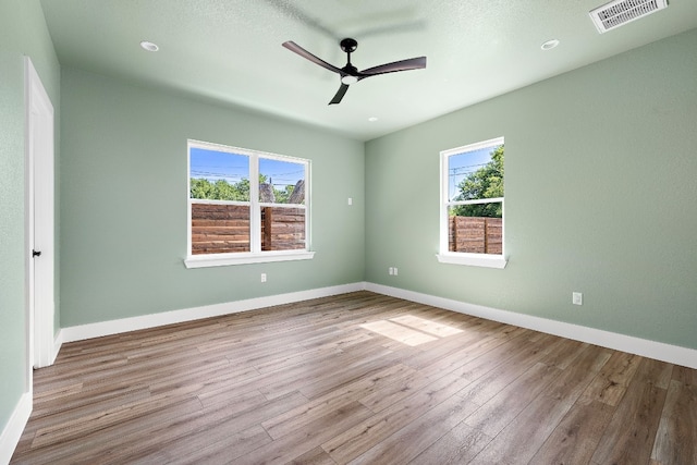 unfurnished room with light wood-type flooring and ceiling fan