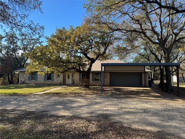 ranch-style house featuring a front lawn and a garage