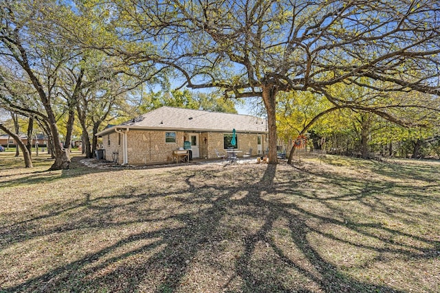 back of property featuring a lawn