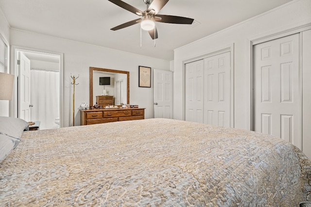 bedroom with ceiling fan and two closets