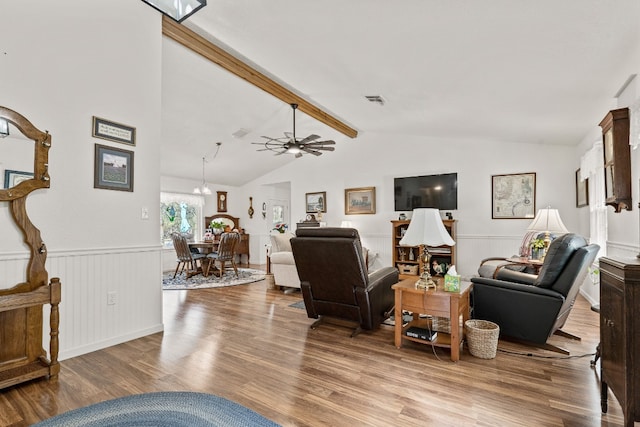 living room featuring hardwood / wood-style floors, lofted ceiling with beams, and ceiling fan