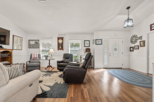 living room with vaulted ceiling and hardwood / wood-style flooring