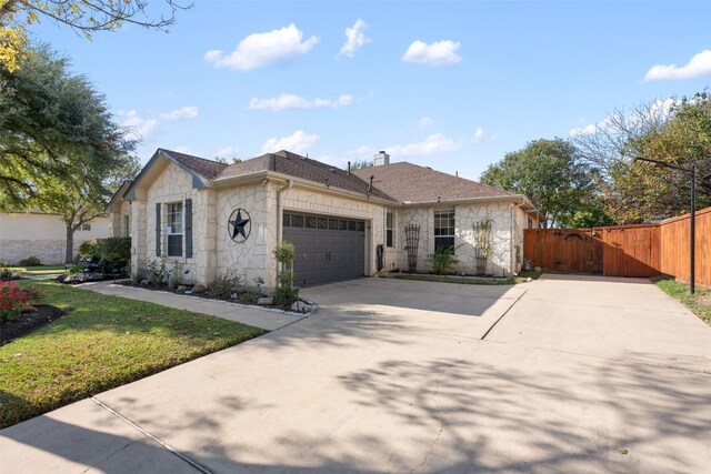 view of front of home featuring a garage and a front yard