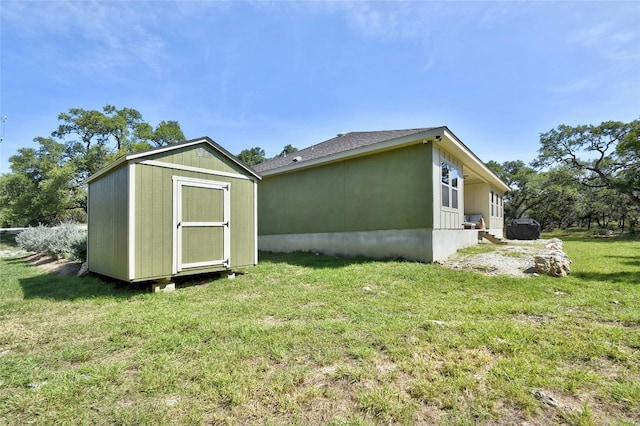 exterior space with a lawn and a storage shed