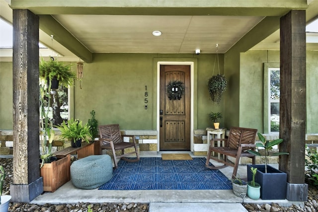 view of exterior entry featuring a porch