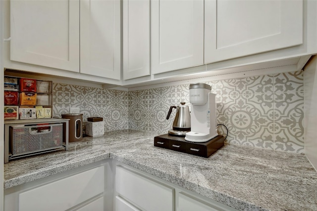 interior details with light stone countertops and white cabinets