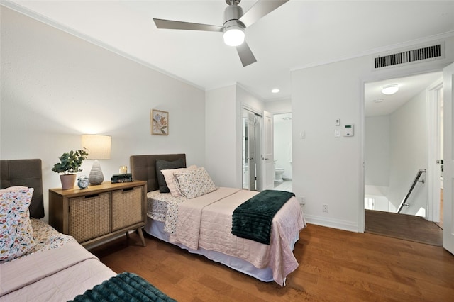 bedroom with ceiling fan, ensuite bathroom, a closet, and dark hardwood / wood-style floors