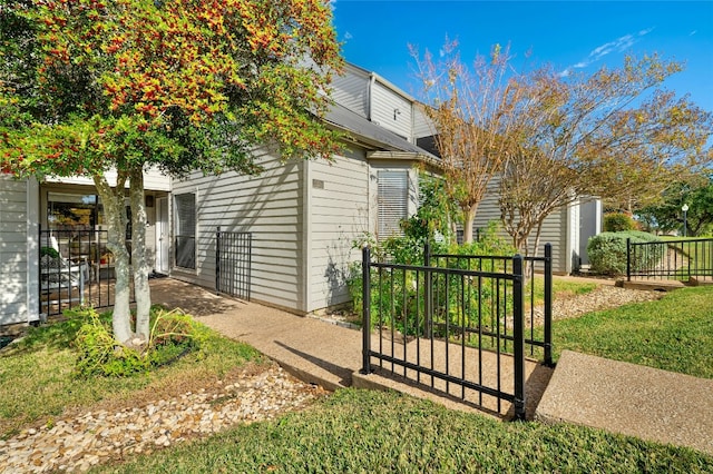 view of side of home with a lawn