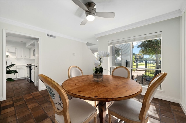 dining room featuring ceiling fan and ornamental molding