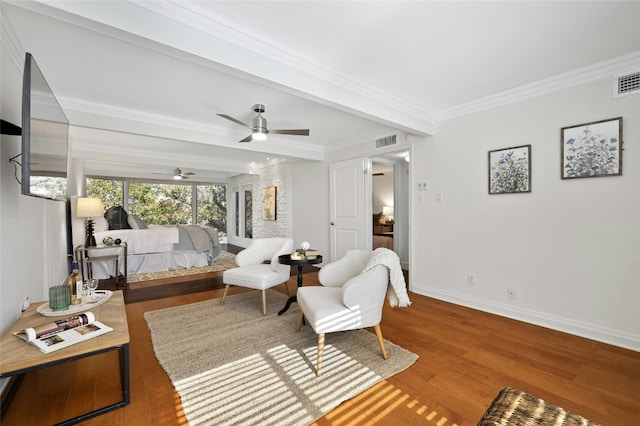 sitting room with ceiling fan, hardwood / wood-style floors, and ornamental molding