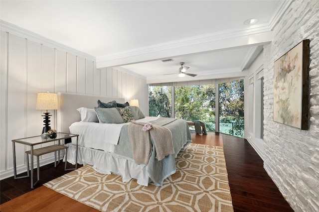 bedroom with ceiling fan, dark hardwood / wood-style floors, a wall of windows, and ornamental molding