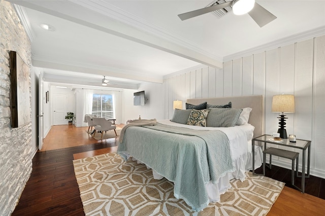 bedroom featuring ceiling fan, dark wood-type flooring, crown molding, and beamed ceiling