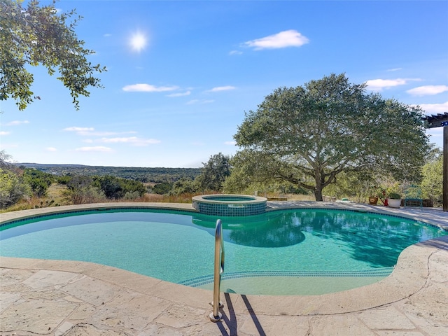 view of swimming pool featuring an in ground hot tub