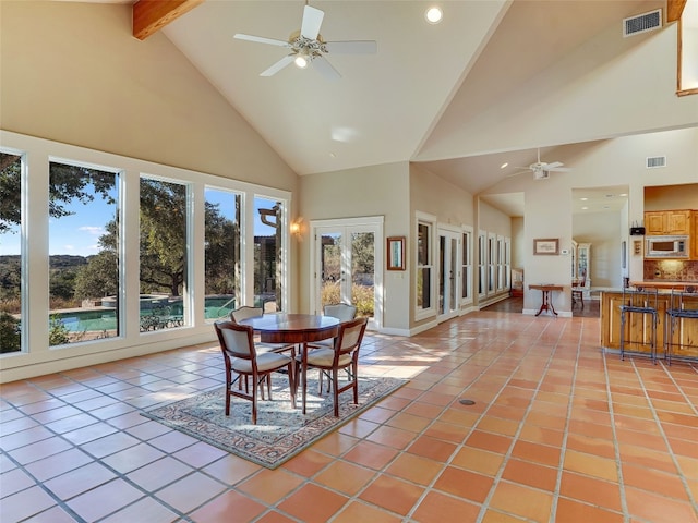 dining space featuring high vaulted ceiling, french doors, ceiling fan, light tile patterned floors, and beamed ceiling