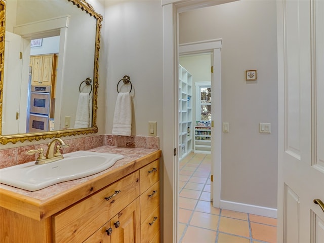 bathroom featuring tile patterned flooring and vanity