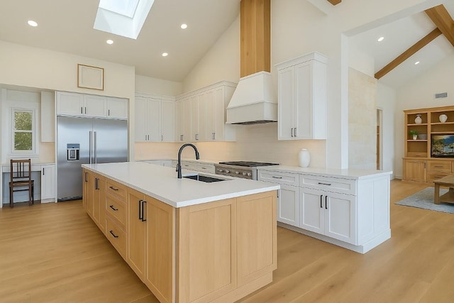 1178 Hidden Creek Dr, Dripping Springs, TX 78620 - kitchen featuring a sink, stainless steel appliances, a skylight, high vaulted ceiling, and light wood finished floors
