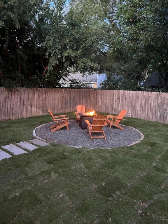 view of playground with a lawn and an outdoor fire pit