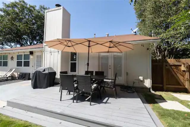 rear view of property with a wooden deck