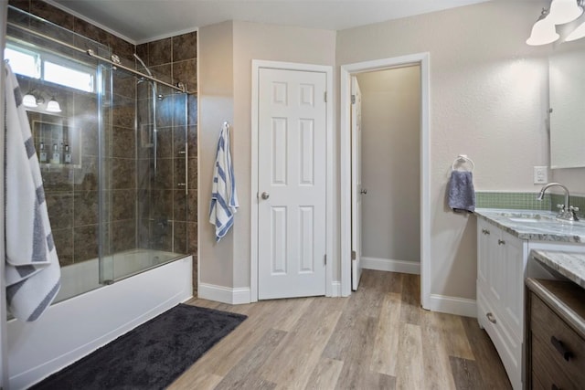 bathroom with vanity, combined bath / shower with glass door, and wood-type flooring