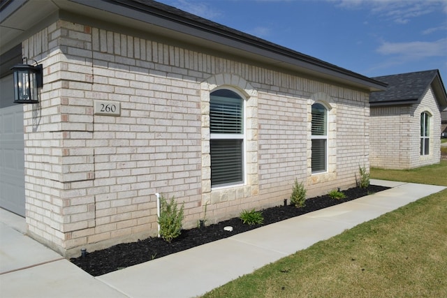 view of property exterior with a lawn