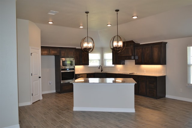 kitchen with a kitchen island, sink, stainless steel appliances, and light hardwood / wood-style flooring