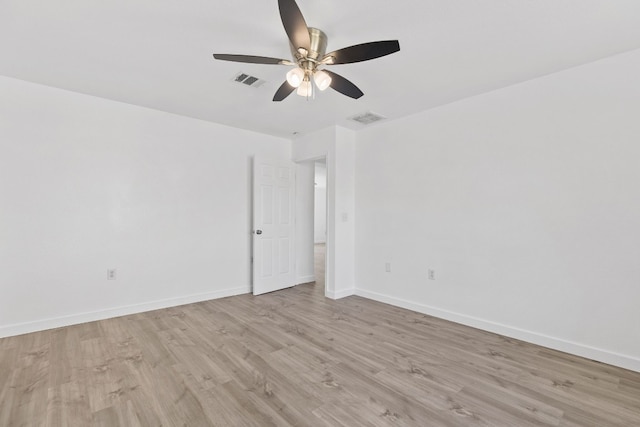 spare room with ceiling fan and light wood-type flooring