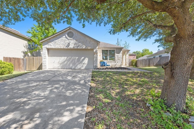 7913 Eudora Ln, Austin, TX 78747 - single story home with stone siding, an attached garage, and driveway
