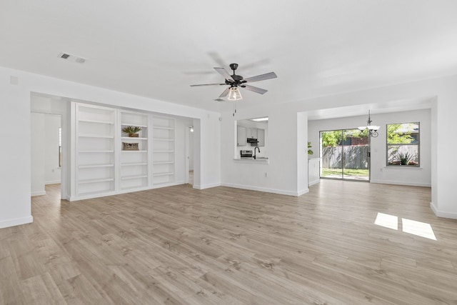 unfurnished living room featuring ceiling fan with notable chandelier, light hardwood / wood-style floors, and sink