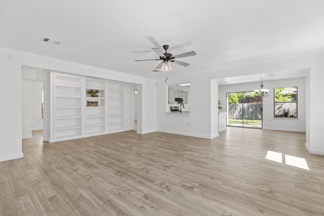 7913 Eudora Ln, Austin, TX 78747 - unfurnished living room with a chandelier, a ceiling fan, baseboards, light wood finished floors, and a sink