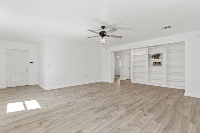 unfurnished living room featuring ceiling fan and light wood-type flooring