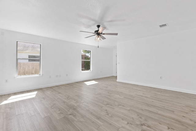 unfurnished room with ceiling fan and light wood-type flooring