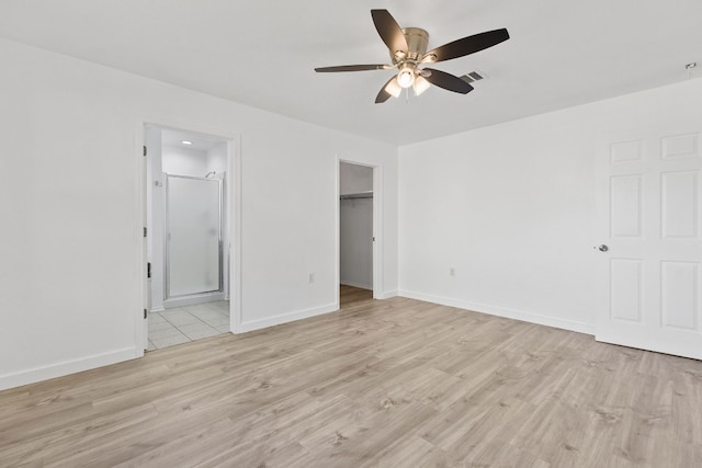 unfurnished bedroom featuring ceiling fan, light hardwood / wood-style flooring, and ensuite bathroom