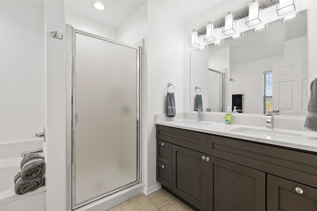 bathroom with tile patterned floors, a shower with door, and vanity