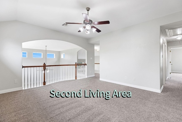 carpeted empty room featuring ceiling fan and lofted ceiling