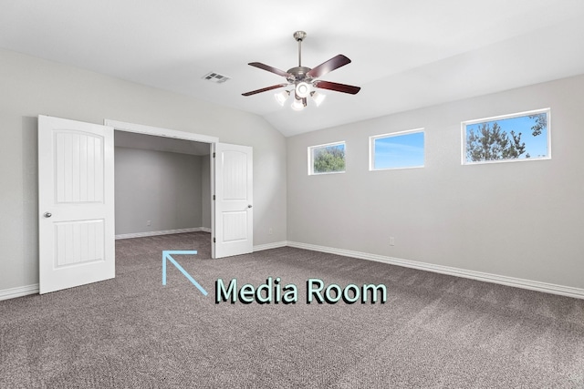 unfurnished bedroom with carpet flooring, ceiling fan, and vaulted ceiling