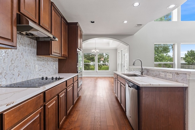 kitchen with dark hardwood / wood-style floors, plenty of natural light, and appliances with stainless steel finishes