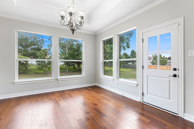 unfurnished dining area with dark hardwood / wood-style floors, a wealth of natural light, and a chandelier