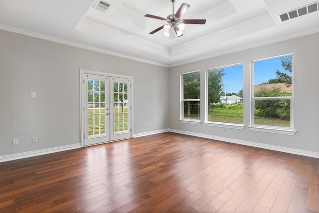 unfurnished room featuring dark hardwood / wood-style flooring, french doors, a wealth of natural light, and a tray ceiling