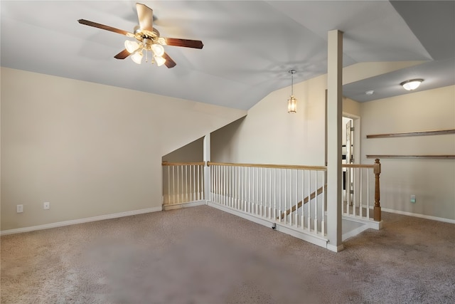 additional living space with lofted ceiling, carpet, a ceiling fan, and baseboards