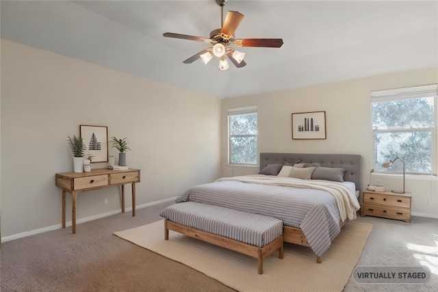 bedroom with light carpet, multiple windows, baseboards, and a ceiling fan