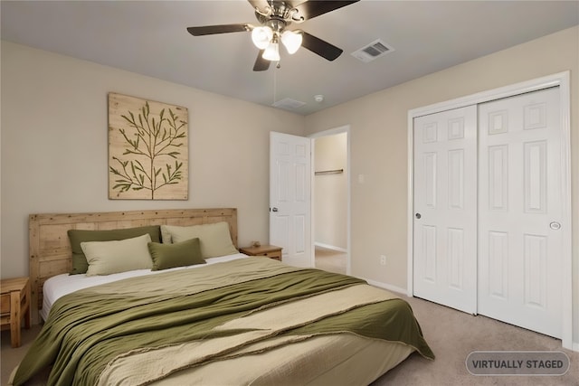 carpeted bedroom with a ceiling fan, baseboards, visible vents, and a closet