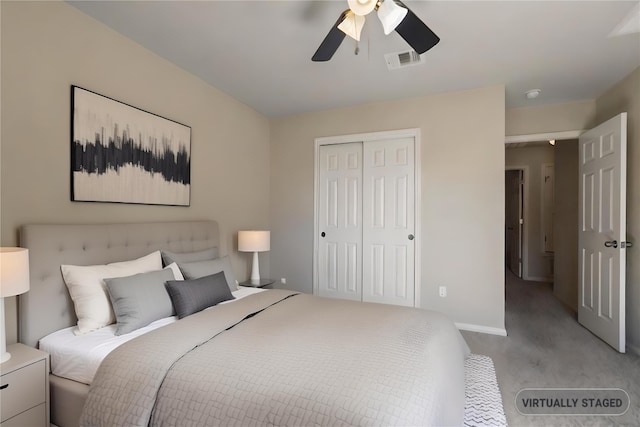 bedroom with a closet, light colored carpet, visible vents, ceiling fan, and baseboards