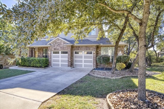 view of front of property featuring brick siding, roof with shingles, concrete driveway, fence, and a garage