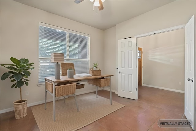 office area with light tile patterned flooring, a ceiling fan, and baseboards