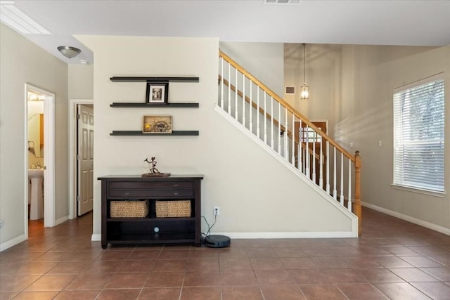 stairs with baseboards, visible vents, and tile patterned floors