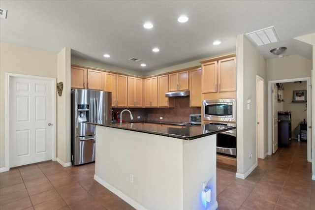 kitchen with a center island with sink, visible vents, stainless steel appliances, under cabinet range hood, and light brown cabinets