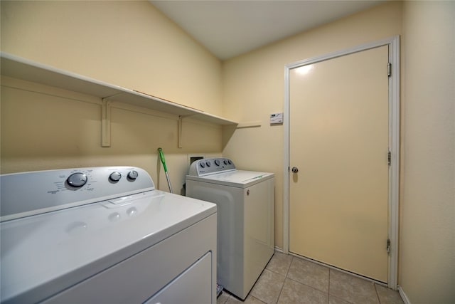 clothes washing area with light tile patterned floors and independent washer and dryer