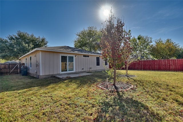 back of property with a patio and a lawn